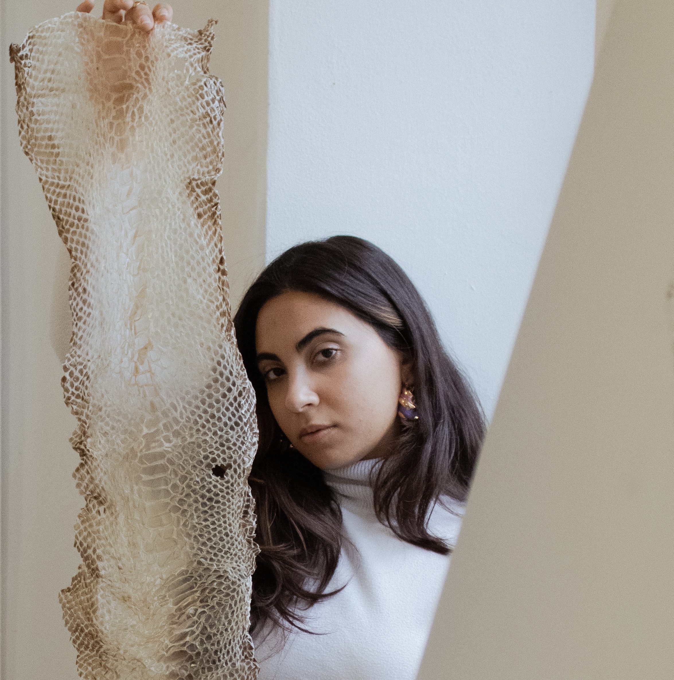 girl standing behind the shed skin of a reptile